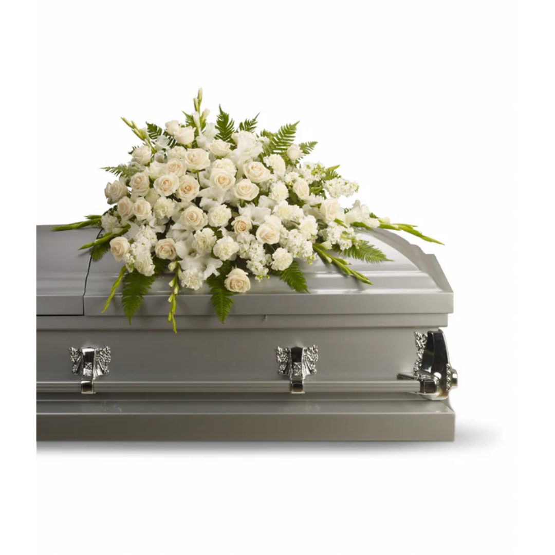 Silken Serenity funeral casket with white floral arrangement